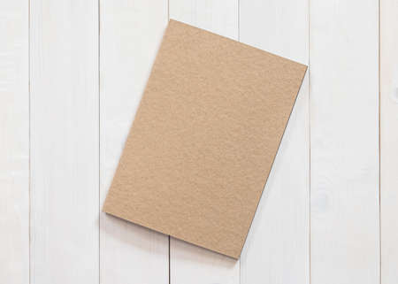 Blank book mock up B5-size catalog magazines, brochure or note cover template recycle brown paper texture flat lay on white color wood table from top viewの写真素材