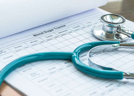 World health diabetes day concept with blood sugar monitoring record and doctor's stethoscopeの写真素材