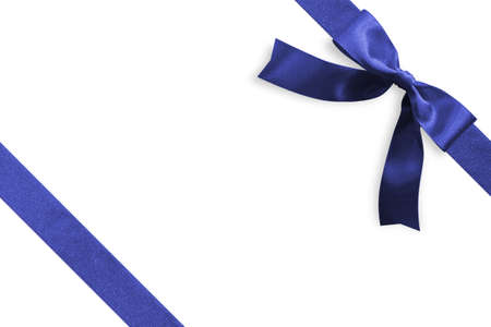 Blue bow satin navy blue ribbon band stripe fabric on corner (isolated on white background with clipping path) for Christmas holiday gift box present wrap design decoration ornament elementの写真素材