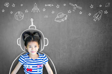 Science technology engineering maths STEM education concept with school girl kid in astronaut helmet...
