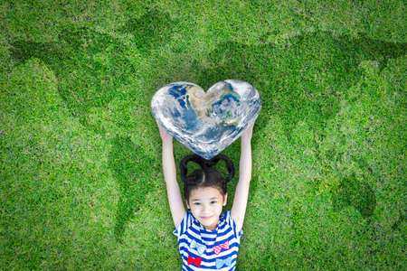 World heart day concept and well being health care campaign with smiling happy kid on eco friendly...