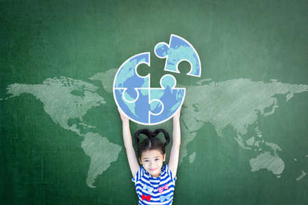 World autism awareness day education concept with girl kid's raising world globe in puzzle pieces on...