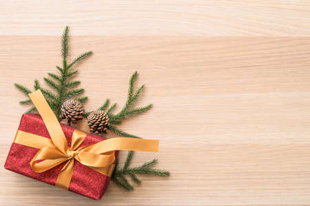 Christmas backdrop with gift box on wooden table background with xmas holiday ornament decorationの写真素材