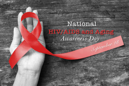 National HIV/AIDS and aging awareness day, September 18 with red ribbon (isolated with clipping...