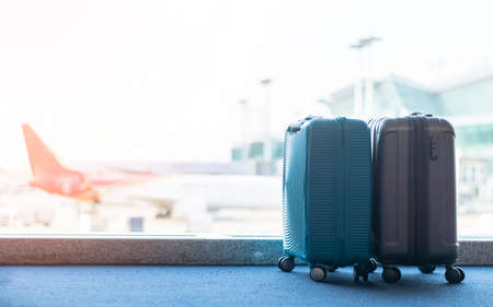 Travel luggage suitcase at the airport terminal in waiting area departure flight for business transportation security traveller belongings safety and vacation journey insurance conceptの写真素材