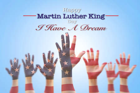 Happy Martin Luther King day, January 18th, I have a dream with American flag pattern on people hands raising upの写真素材