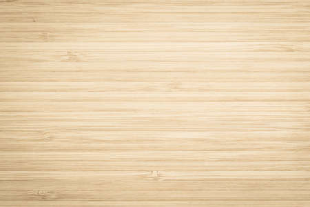 Wood texture old aged bamboo wooden kitchen cutting board grainy detail background in light gold brown beige colorの写真素材