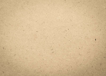 Old aged beige brown particle pressed wood panel of oriented strand board (OSB) texture background in light cream sepia colorの写真素材