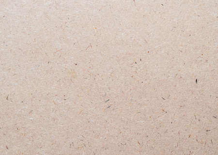 Beige particle pressed wood panel of oriented strand board (OSB) texture background in light brown cream sepia colorの写真素材