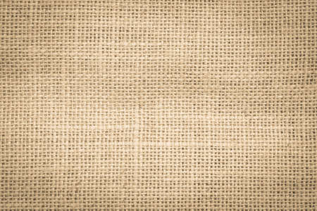 Hessian jute sackcloth woven burlap texture background in sepia cream old aged brown colorの写真素材