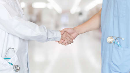 Medical doctor teamwork, surgeon, anesthetist, ER surgery team hand shaking in hospital clinic for  professional cooperative clinical work and collaboration on patient care operation conceptの写真素材