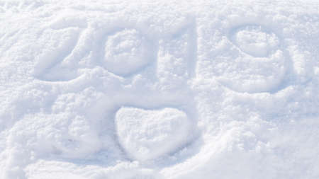 2019 new year & Christmas winter snow white background seasonal happy greeting on snowy fluffy ski surface backdrop with love heart for xmas holiday celebration backdropの写真素材