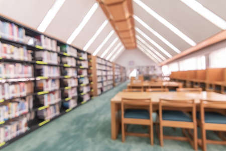 School library or study class room, education blur interior background with blurry view of books on...