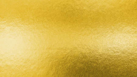 Gold texture background metallic golden foil or shinny wrapping paper bright yellow wall paper for design decoration elementの写真素材