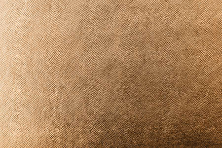 Copper gold metallic wrapping foil paper shiny orange background for wall paper leather texture decoration elementの写真素材