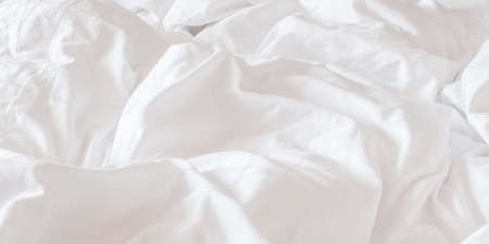 White bed sheet blanket, wrinkled duvet, crumpled comforter cloth used in hotel, resort or home...