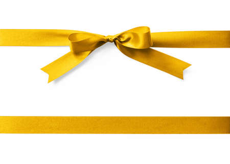 Gold satin ribbon stripe fabric bow isolated on white backgroundの写真素材