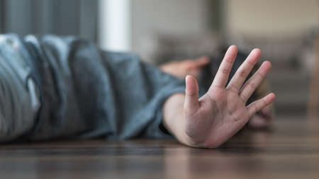 Child abuse and crime prevention concept with kid lying on the floor with hand stopping aggressive action for International Day of Innocent Children Victims of Aggressionの写真素材