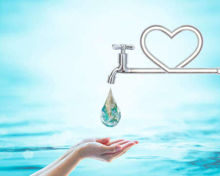 Saving water and world environmental protection concept with faucet in love heart shape.の写真素材