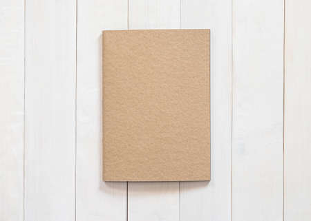Blank book mock up B5-size catalog magazines, brochure or note cover template recycle brown paper texture flat lay on white color wood table from top viewの写真素材