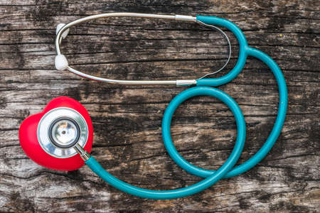 Healthcare insurance and world heart health day concept with red heart love with medical doctor physician's stethoscopeの写真素材