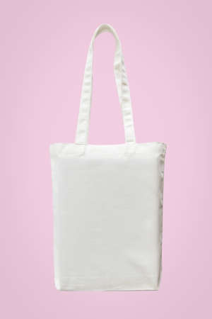 White shoulder canvas tote bag fabric cloth for woman's shopping sack mockup template isolated on pastel pink background (clipping path)の写真素材