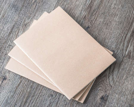 Blank book mock up, catalog, magazines or note cover template with recycle brown paper texture on table floorの写真素材