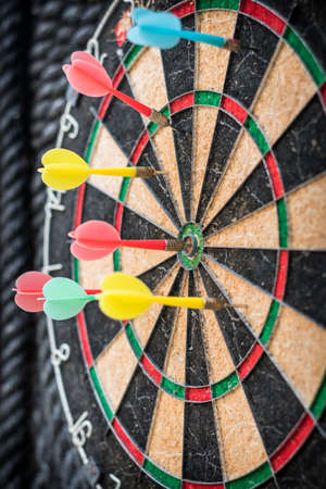 Colorful dart target game with one win arrow hit on middle point spot and many missing for competitive business marketing conceptの写真素材