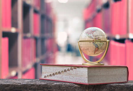 FEBRUARY 26, 2016 - BANGKOK, THAILAND: Globe model on textbook, or dictionary on  table in school or university library, educational resource for knowledgeの写真素材