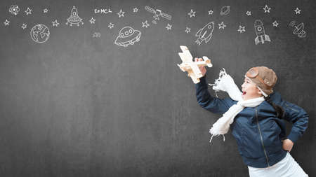 Kid in pilot costume and imagination dream in learning inspiration world in innovative science technology engineering maths STEM education and universal children's day conceptの写真素材