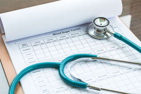 World health diabetes day concept with blood sugar monitoring record and doctor's stethoscopeの写真素材