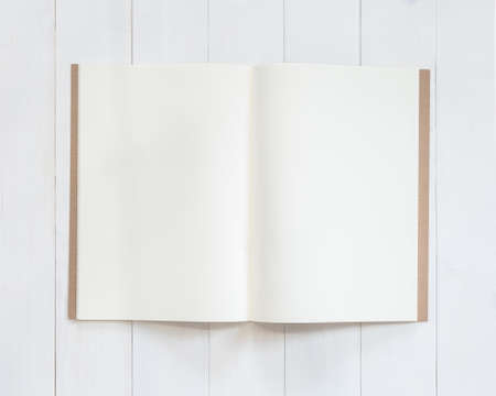 Book mockup template open page  A4-size recycle paper flat lay on white wood table from top viewの写真素材
