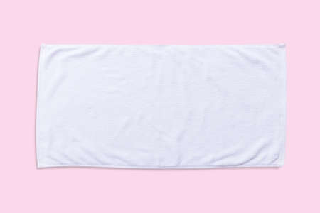 White beach towel mock up isolated with clipping path on pastel pink background, flat lay top viewの写真素材