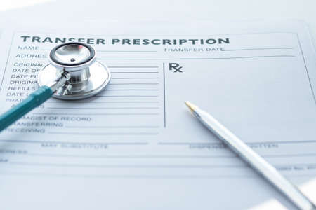 Doctor's notepad work with patient's medical health record blank paper form for prescription with...
