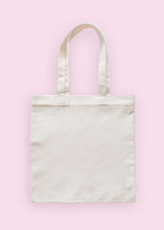 Tote bag canvas fabric cloth eco shopping sack mockup blank template isolated on pastel pink background (clipping path)の写真素材