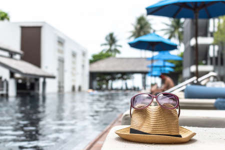 Summer holiday vacation relaxation with hat and sunglasses to protect from UV sunlight on sunny day skyの写真素材