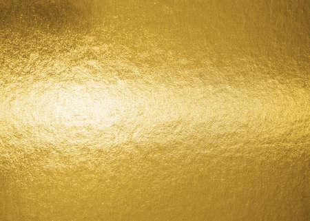 Gold background metallic golden foil texture or shinny wrapping paper bright yellow wall paper for design decoration elementの写真素材