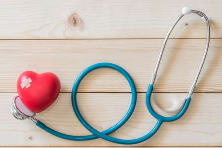 World health day campaign with red love heart  with cross bandage and medical doctor's stethoscope, first aid conceptの写真素材