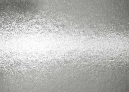Silver background metallic texture wrapping foil paper shiny white grey metal backdrop for wall paper decoration elementの写真素材