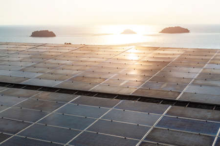 Solar panel installed on building roof  for photovoltaic cell or PV system, renewable and sustainable power supply alternative energy source usable on islandの写真素材