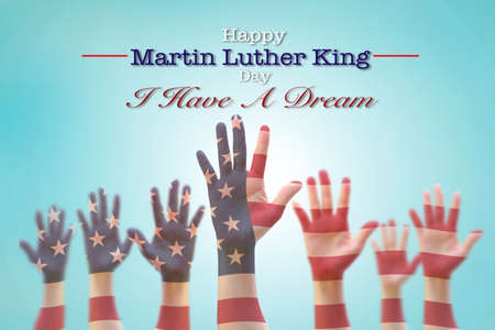 Happy Martin Luther King day, January 18th, I have a dream with American flag pattern on people hands raising upの写真素材
