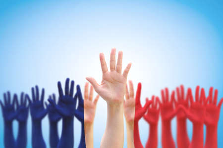 France national flag pattern on people palm hands raising up on blue sky backgroundの写真素材