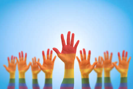 LGBT equal rights movement and gender equality concept with rainbow flag on people's hands upの写真素材