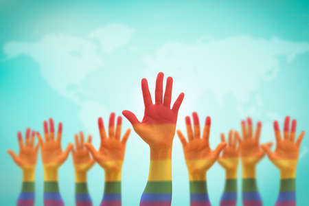 LGBT equal rights movement and gender equality concept with rainbow flag on people's hands upの写真素材