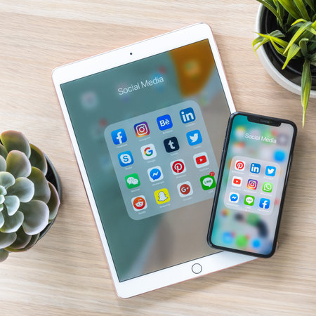 BANGKOK, THAILAND- June 26, 2019: Social media app, mobile cross-channel internet online application for people lifestyle in  multi-channel digital 4.0 age with logo on iPhone X and ipad pro touchscreenのeditorial素材