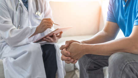 Men's health exam with doctor or psychiatrist working with patient having consultation on diagnostic...