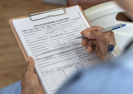 Health insurance claim form application for medicare coverage and medical treatment for patient with illness, accident injury and admitted in hospital wardの写真素材