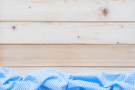 Oktoberfest background with blue tablecloth Bavarian check pattern on white wood table for Germany...