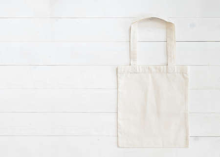 Tote bag mock up canvas fabric cloth shopping sack on white woodの写真素材