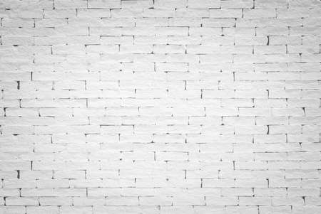 Brick wall background painted texture in stained old aged stucco light white cream gray colorの写真素材